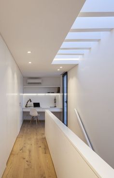 the interior of a modern home with wood flooring and white walls, along with wooden floors