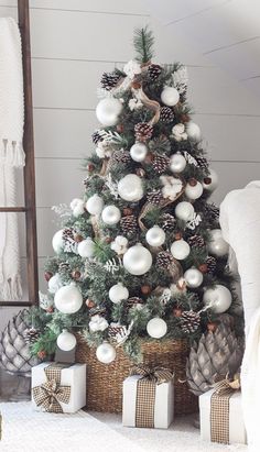 a christmas tree with white balls and pine cones