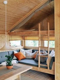 a living room filled with lots of furniture and wooden walls on top of each other