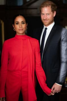 prince harry and his wife, the duke of cambridge pose for a photo in their red outfits