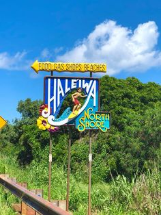 there is a sign that says halewa on the side of the road with trees in the background