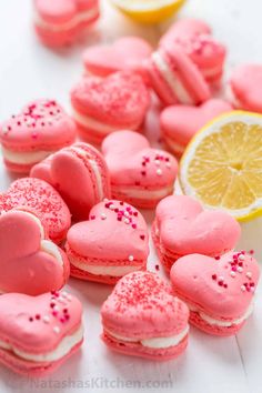 pink heart shaped macaroons with sprinkles and lemon slice on the side