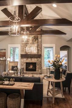 a living room filled with furniture and a fire place in the middle of a room