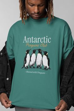 "Celebrate your love for penguins with this exclusive 'Antarctic Penguins Club' T-shirt! Featuring a beautifully hand-drawn design of four charming penguins, this shirt is perfect for any penguin enthusiast or animal lover. Made with high-quality fabric, it offers both comfort and style, making it a great addition to your wardrobe or a thoughtful gift for someone obsessed with these adorable creatures. Whether you wear it to a wildlife event, a casual outing, or just around the house, this penguin tee is sure to turn heads and start conversations. Ideal for nature lovers, bird watchers, and anyone who appreciates unique animal art." ----How To Order----- 1-) Please, check and review all photos 2-) Choose your t-shirt size and color *Different styles of shirts may have different shades of s Penguins In Sweaters, Penguin Hoodie, Penguin Polo Shirt Men, Casual Crew Neck T-shirt With Fish Print, Penguin T Shirt, Bird Watchers, Cute Penguins, Unique Animals, Penguins