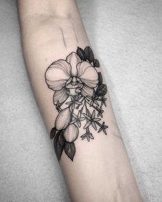 a black and white flower tattoo on the arm