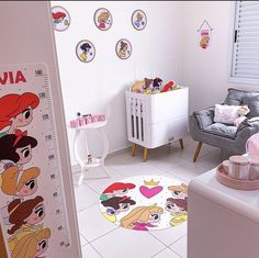 a baby's room with disney princess decals on the wall, and a large growth chart