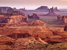 the desert is filled with large rocks and cliffs