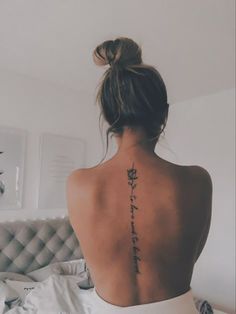 a woman with a flower tattoo on her back