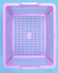 a purple plastic basket sitting on top of a blue surface