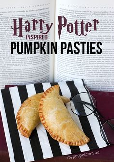 harry potter inspired pumpkin pasties on a striped napkin with reading glasses next to them