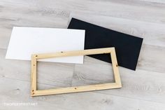 three different types of wood frames sitting on top of a white and black piece of paper