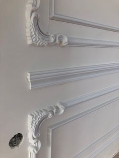 the corner of a room with white paint and molding on it's walls