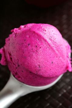 a scoop of pink ice cream sitting on top of a table