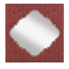 a red and gold wall mirror with an ornate design on the bottom half of it