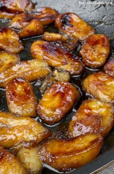 some bananas are cooking in a pan on the stove top and it looks like they have been cooked