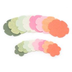 several different colors of felt hearts on a white background