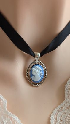 "Take a peek at this gorgeous blue cameo necklace! This Victorian necklace choker is the perfect accessory for your vintage-inspired wardrobe. A soft, black ribbon choker necklace that is just the right size for you (size can be selected in the drop-down menu). The focal piece of this necklace is the classic and elegant cameo pendant in a vintage silver setting.  This cameo choker is the perfect gift for someone that likes Gothic cameo jewelry and Victorian-era jewelry. --- SIZE: The Victorian c Black Ribbon Choker Necklace, Black Ribbon Choker, Cameo Choker, Something Blue For Bride, Victorian Gothic Jewelry, Ribbon Choker Necklace, Victorian Accessories, Victorian Cameo, Blue Bride