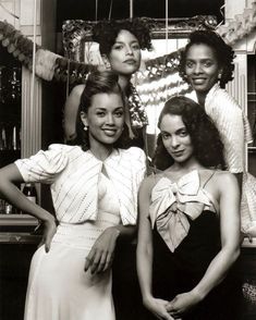 an old black and white photo of four women