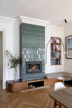 a living room filled with furniture and a fire place in the middle of a room