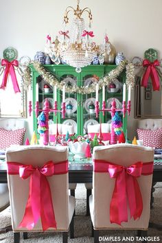 the dining room table is decorated with pink bows