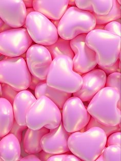 many pink hearts are scattered on the ground