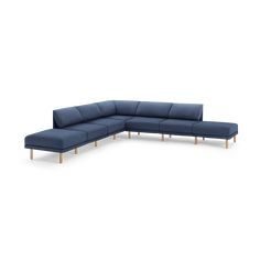 a blue sectional couch with wooden legs