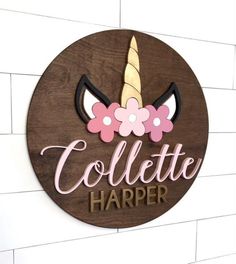 a wooden sign that says collette harper with a unicorn horn