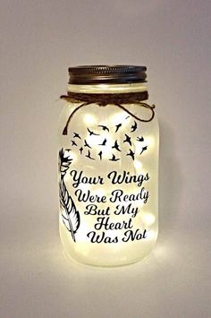 a lighted mason jar with a message on it that says, your wings were ready but my heart was not