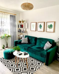 a living room with green couches and black and white rugs on the floor