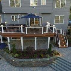 an aerial view of a deck and patio with stairs leading up to the upper level