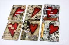 four tags with red hearts on them are arranged in the shape of heart's