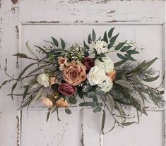 a bouquet of flowers is hanging on the door