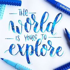 the world is yours to explore written on a piece of paper surrounded by blue crayons