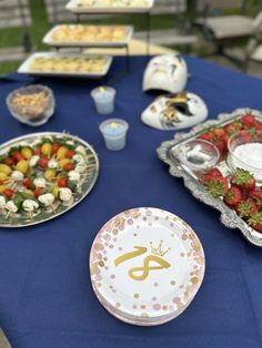 a blue table topped with plates filled with food