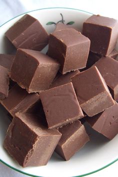 a white bowl filled with chocolate pieces on top of a table