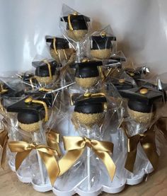 graduation hats and diploma caps are wrapped in clear cellophane with gold ribbon around them