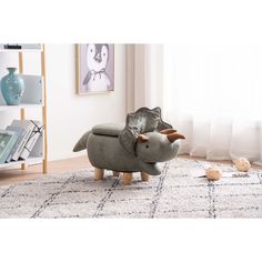 an elephant shaped chair sitting on top of a rug