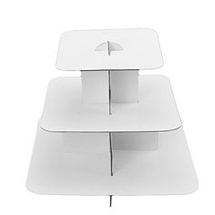 two white tables are stacked on top of each other with an umbrella sticking out of them