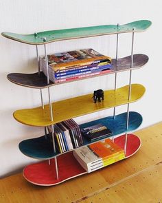 three skateboards are stacked on top of each other in the shape of bookshelves