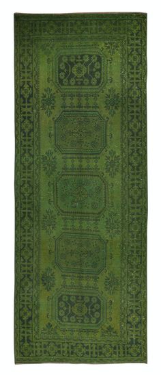 a green rug with an intricate design on the bottom and sides, in different colors