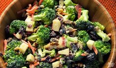 a white bowl filled with broccoli and croutons on top of a table