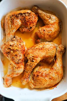 chicken in a white dish with gravy on the side, ready to be cooked