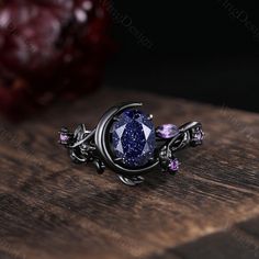 Oval cut Blue Sandstone engagement ring set unique Moon style amethyst cluster ring gothic black gold rings for women leaf branch rings -----Ring Information----- ✦Engagement Ring Metal Type: 925 sterling silver, 10K/14K/18K Solid Gold, Platinum Center stone: Blue sandstone Stone size: 6x8mm oval cut Side stone: amethyst ✦Wedding Band Stone: Round amethyst  ✦ Please feel free to contact me if you have any questions or you are interested in custom order. ✦Black rhodium plating: Rhodium, a valuabl Black Birthstone Jewelry For Promise Ring, Metal Promise Ring, Black Wedding Jewelry With Birthstone, Black Birthstone Jewelry For Wedding, Celestial Metal Ring Jewelry, Celestial Style Metal Ring Jewelry, Celestial Jewelry With Prong Setting As Gift, Elegant Black Amethyst Jewelry, Mystical Gemstone Rings For Formal Occasions