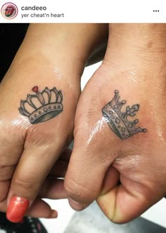 two people holding hands with tattoos on their fingers and one has a crown tattooed on it