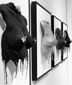 black and white photograph of artwork hanging on the wall in an art gallery with dripping paint