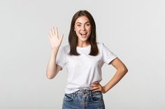 a woman in white shirt standing with her hands up