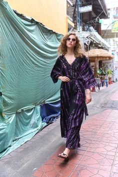 Discover the Timeless Charm of Boho Kaftans - purple  tie dye kaftan- where breathable fabrics, comfort, and stylish handmade designs come together. Each kaftan is crafted with care to offer you a unique blend of breezy and ease, perfect for any occasion.  Embrace the bohemian spirit with our versatile and chic kaftans, designed to keep you looking and feeling chic all day long. This dress can be suitable for vacations, celebrations and can also be used as an everyday item. ⚠️Size + Fit⚠️ ️Model height is 1725cm/5'74ft, American small size * 100% Soft Rayon fabric, unlined; please note that the material may be sheer * Maxi length * Lightweight feel * Hand Tie-dye pattern * Kaftan design * V-neckline * Relaxed sleeves * Comes with a matching belt +  One-size dress, suitable for women of  S Long Purple Kaftan For Festival, Purple V-neck Kaftan For Festival, Boho Kaftans, Tie Dye Kaftan, Kaftan Design, Kaftan Designs, Long Kaftan, Hand Tie, Tie Dye Maxi Dresses