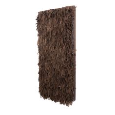 a brown shaggy rug hanging on the wall in front of a white background with no one around it