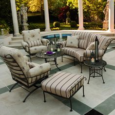 an outdoor patio with chairs, tables and ottomans in front of a gazebo