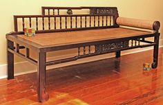 a wooden bench sitting on top of a hard wood floor